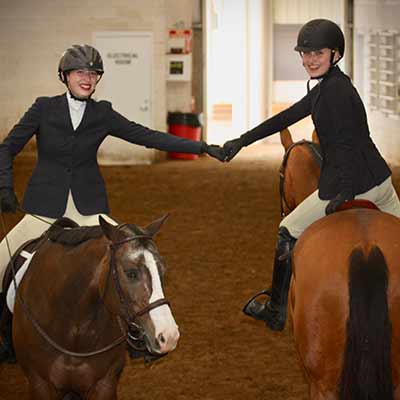 Two Deerfield Farm show team members on horses