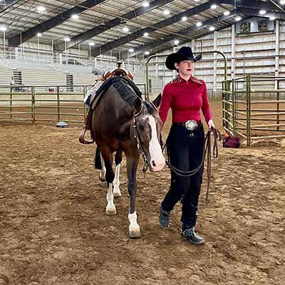 Deerfield World team member walking horse