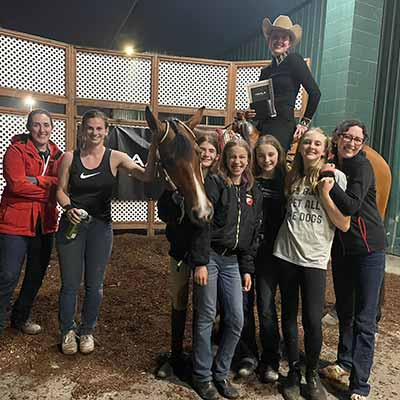 Deerfield 2022 equestrian team at regional show with Sam's plaque