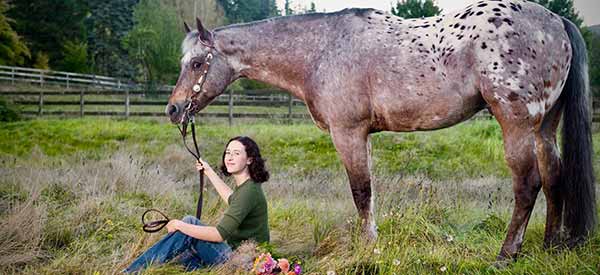 young women on horses in a corral